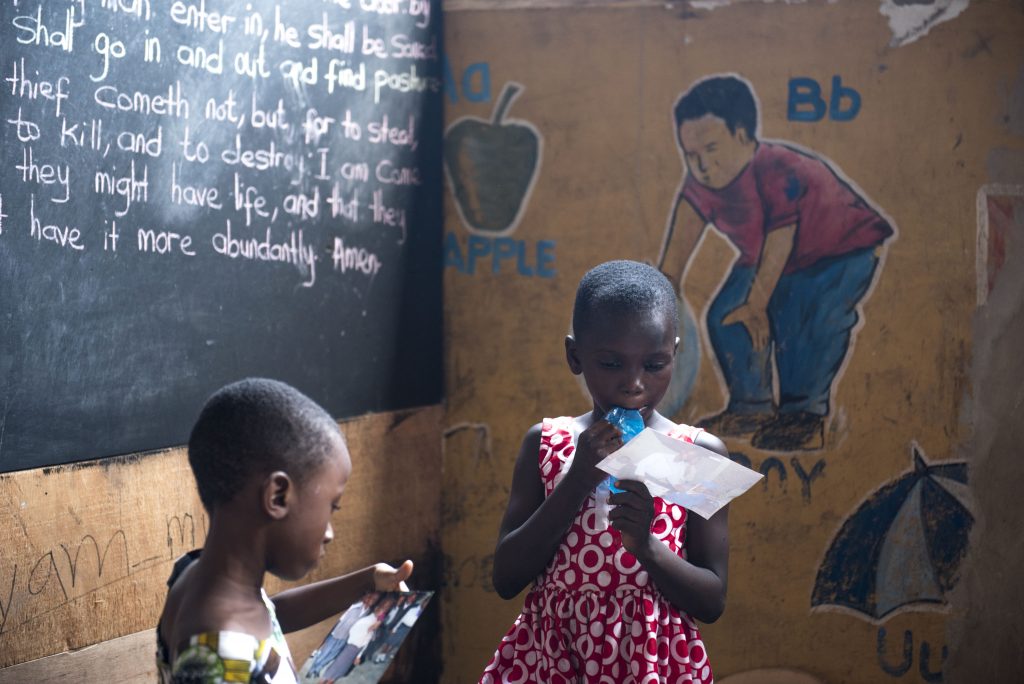 Children at the Seventh Day Adventist Church School in Maamobi, Accra, Ghana drink from plastic water bags