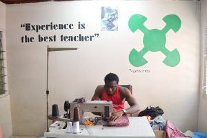 Kwame “Sly” Acheampong sews an iPad case